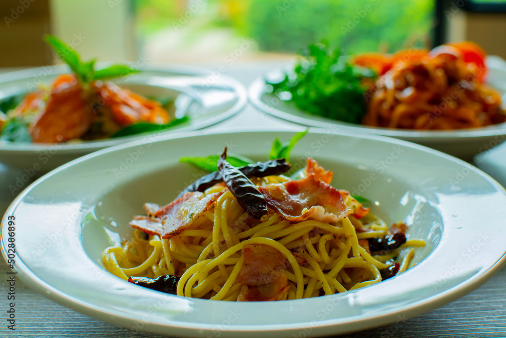 Plate of delicious pasta with mushrooms on table