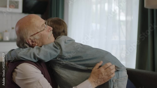 The child kisses his grandfather's hand, celebrates Eid or Father's Day,A child kissing his grandfather's hands during the feast (Ramadan or Şeker Bayram). People who adhere to Muslim traditions.