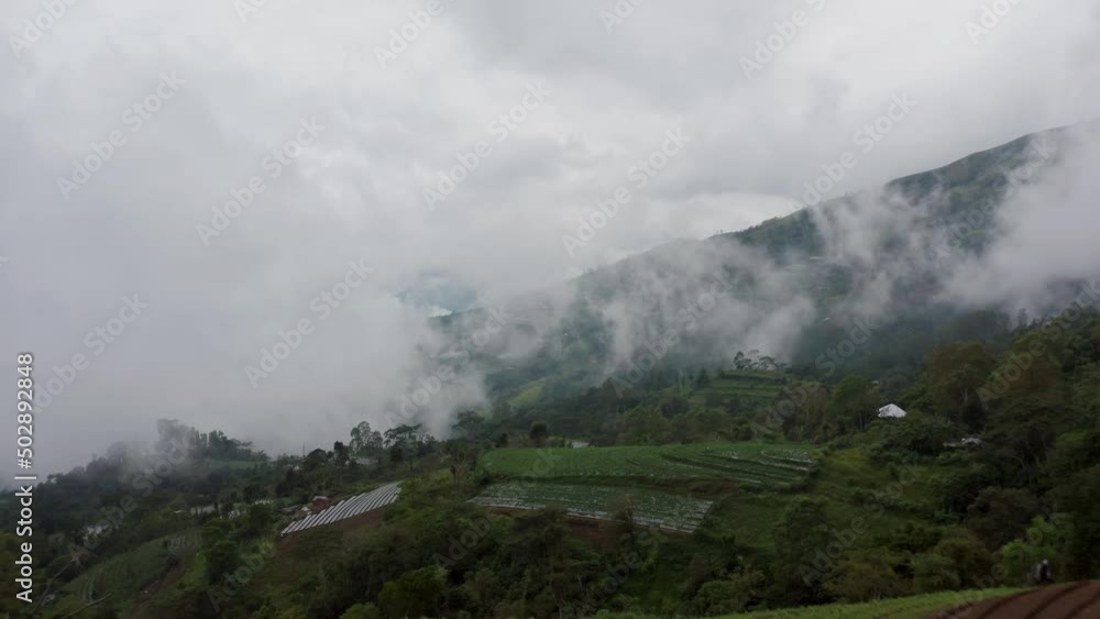Low mist creating greyish scene in remote rural tropical mountain landscape Low mist creating greyish scene in remote rural tropical mountain landscape