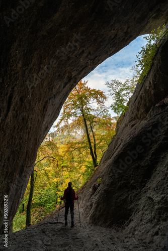 Silhouette of tourist inside cave called Dragon hole in Sulov rocks at Slovakia