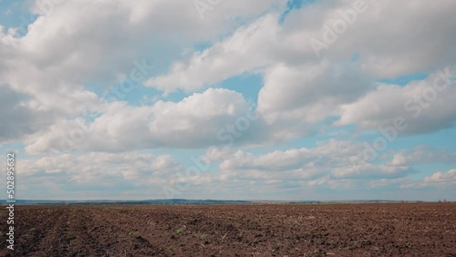 Agricultural landscape arable field. business agriculture concept soil sky. walk on brown black arable a land. preparation for sowing crops in agriculture landscape motion steadicam. farming field photo