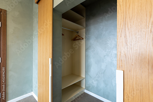 Empty closet with wooden door