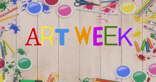 Illustration of art week text with paints, crayons, colored pencils and paint brushes on table