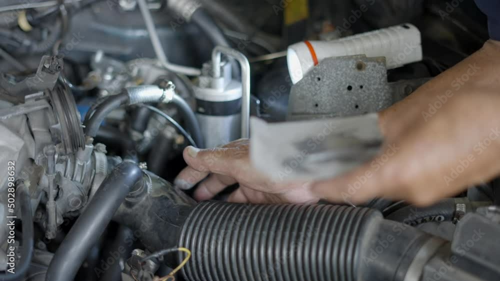Hands Of An Auto Mechanic Using Epoxy Resin To Fix The Leak On Radiator