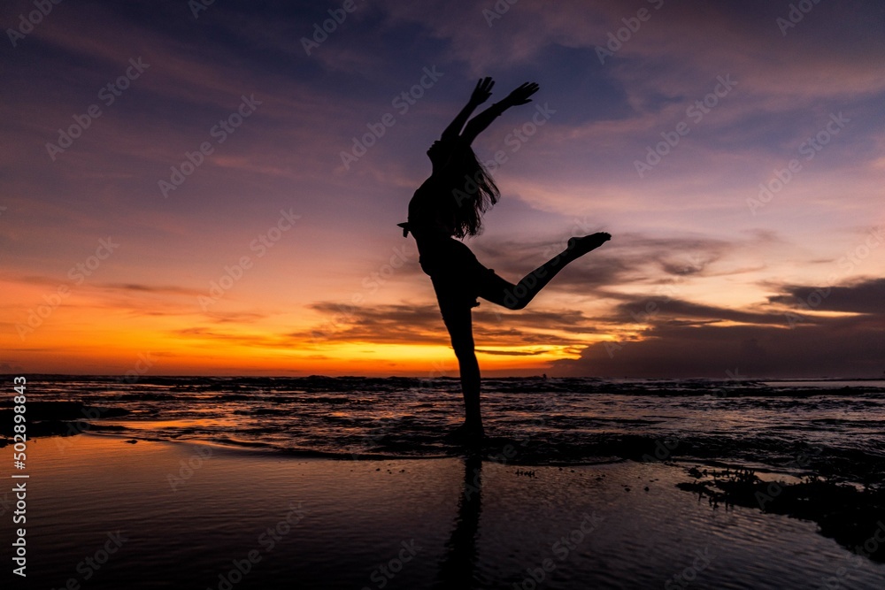 silhouette of person jumping on the beach