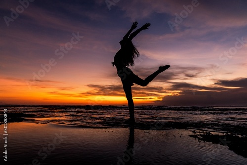 silhouette of person jumping on the beach