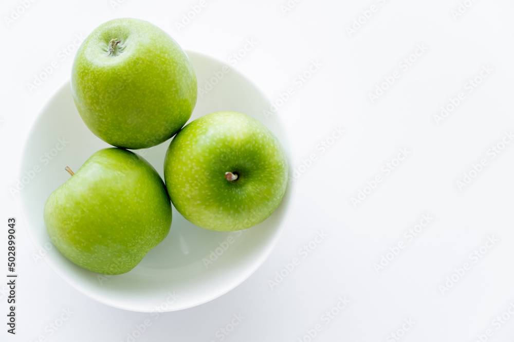 top view of fresh apples in bowl on white. top view of fresh apples in bowl on white.