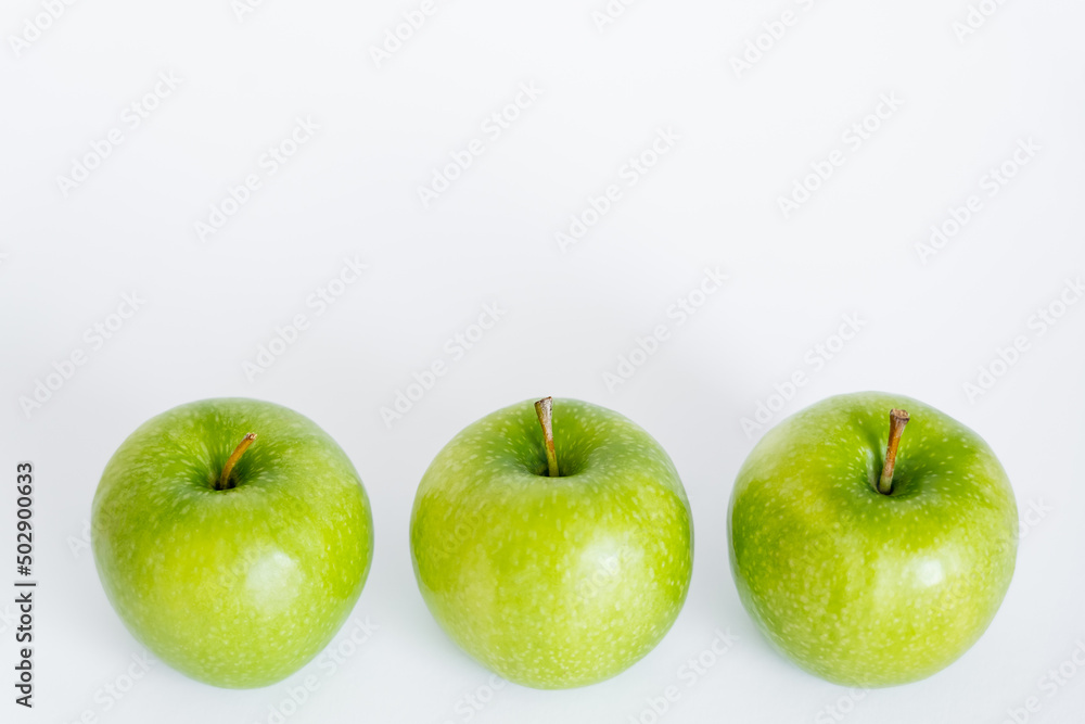 high angle view of green and ripe apples on white. high angle view of green and ripe apples on white.