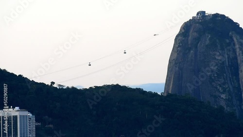 Big Sugarloaf mountain (Pão de Açúcar) cable car lift during sunset above Cobacabana beach and Guanabara Bay in Rio de Janeiro, Brazil photo