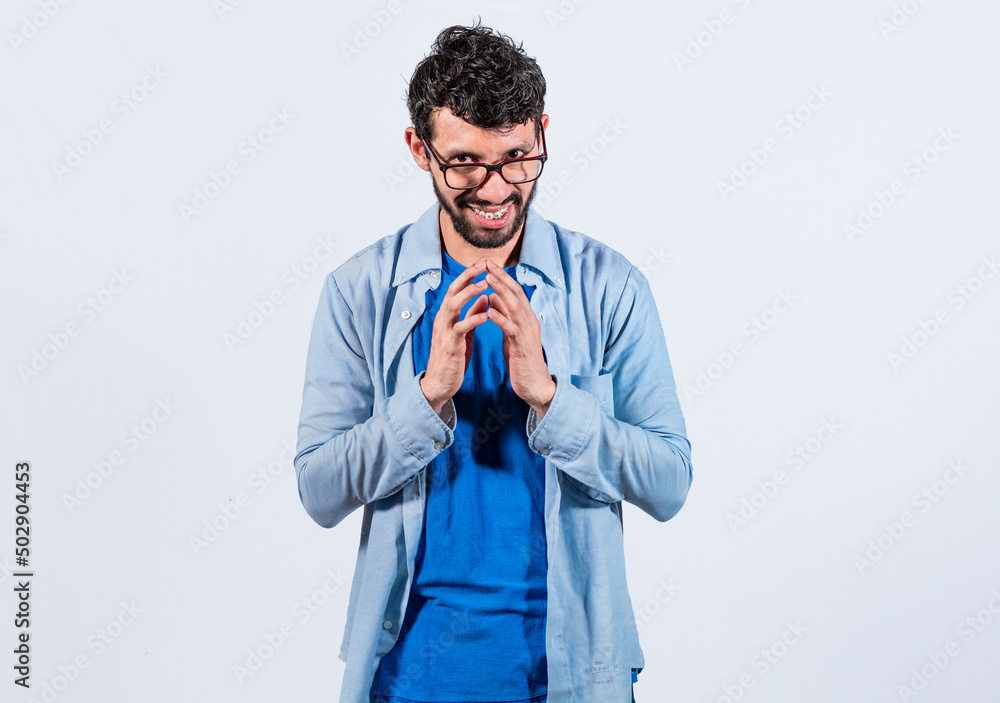 Cunning man rubbing his hands on isolated background, person rubbing his hands planning something, concept of cunning man planning something - obrazy, fototapety, plakaty 