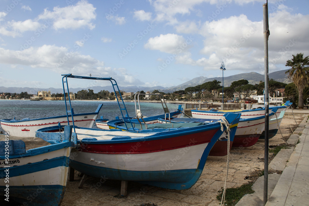 evocative image of fishing boats moored in the harbor in a small fishing village in Sicily, Italy
evocative image of fishing boats moored in the harbor in a small fishing village in Sicily, Italy