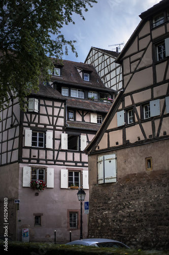 historical wooden half-timbered architecture of the alsace town on the river bank