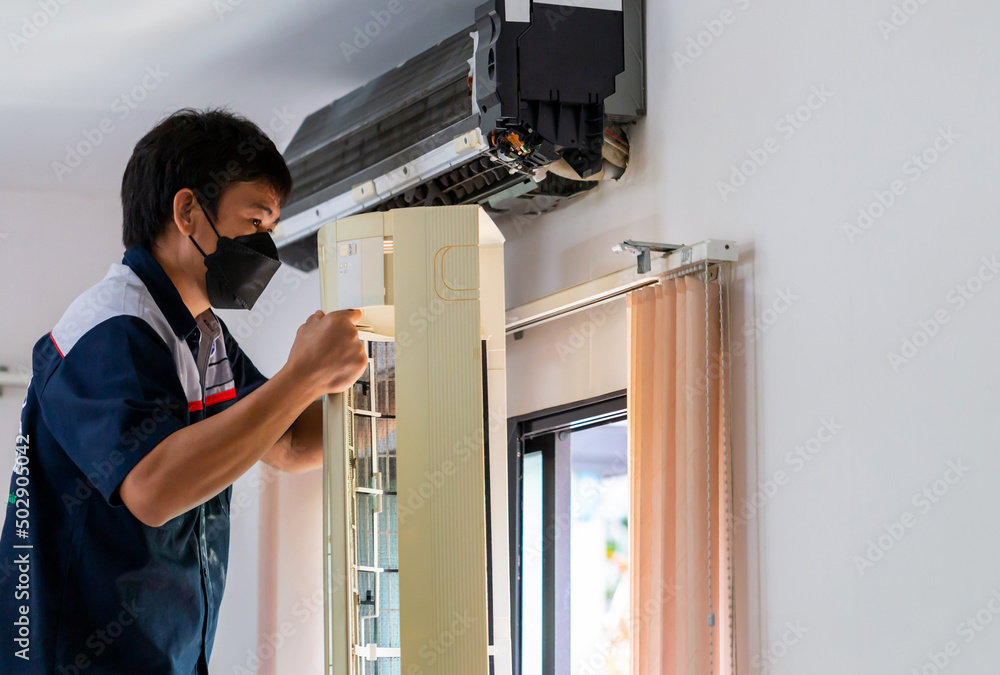 Air Conditioning Repair, Repairman fixing air conditioning system, Male technician service for repair and maintenance of air conditioners Air Conditioning Repair, Repairman fixing air conditioning system, Male technician service for repair and maintenance of air conditioners