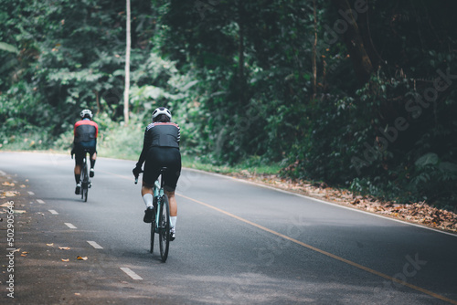Women on road bikes exercise to stay healthy. © Oatakoi