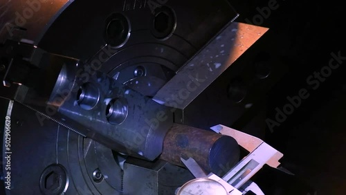 Hand holding the measuring device in the Industrial metalworking cutting automation process by milling CNC.