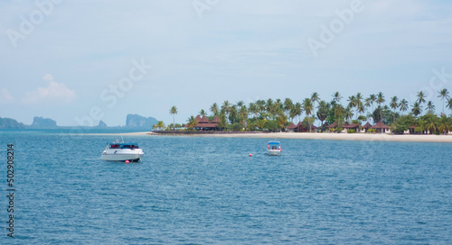 tropical island and speed boat