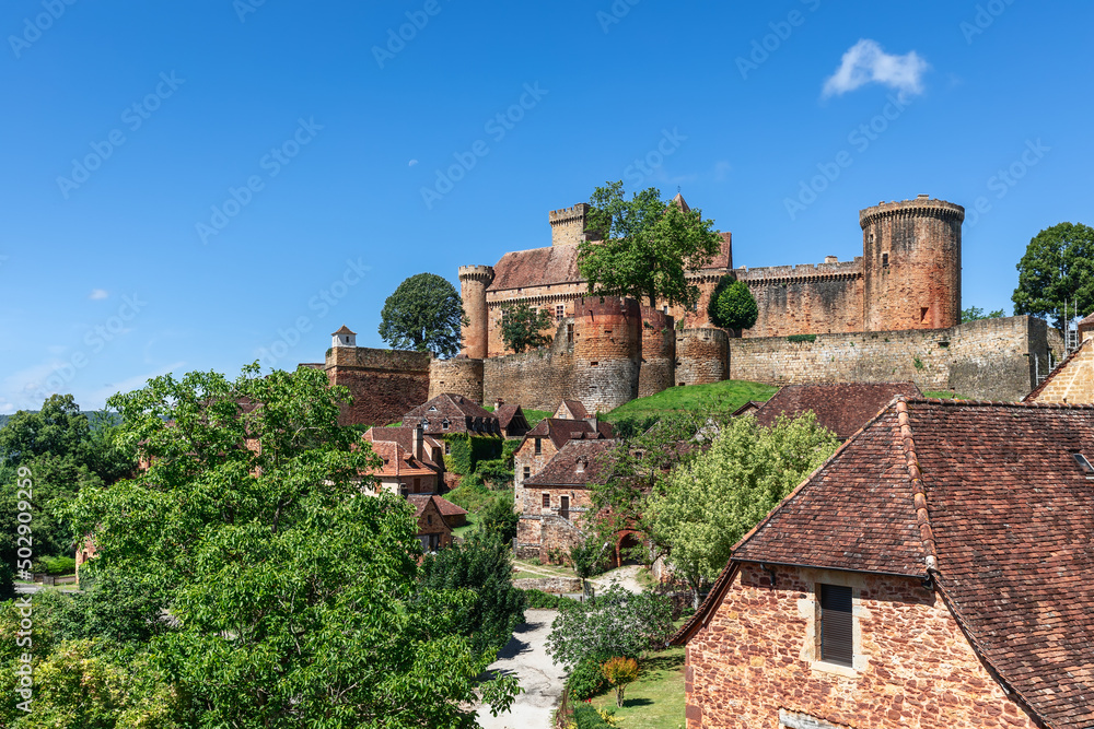 Сommoner settlement located on hill slopes and fortress castle Chateau de Castelnau-Bretenoux in Dordogne Valley, Prudhomat, Lot, Occitanie, France