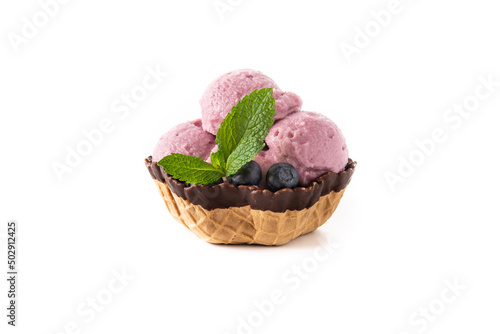 Blueberry ice cream scoop in waffle basket isolated on white background