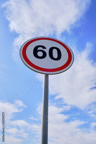 Road sign warning speed limit 60 kilometers per hour.