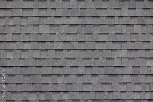 dark grey asphalt tiles decoration on house wall or roof.  © Rattanachat