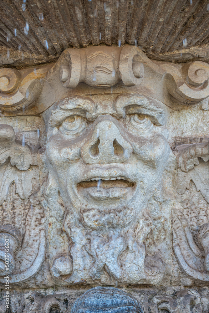 Ancient sculpture of funny, tricky and joyful dickens at fountains in historical downtown of Dresden, Germany, details, closeup. Concept of art and historical heritage.