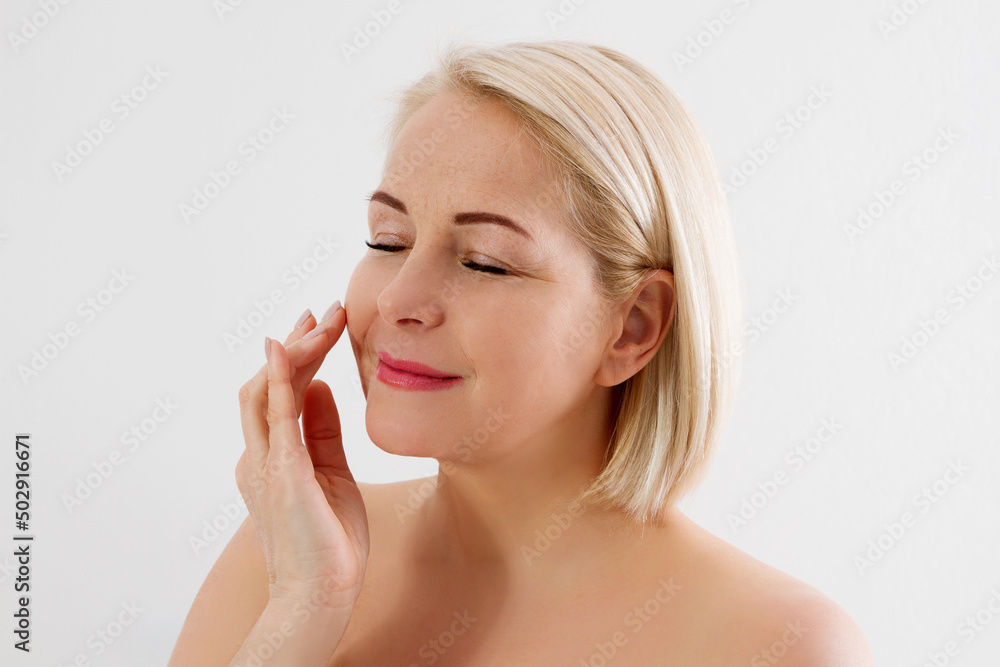Beauty middle age woman face portrait. Spa and anti aging concept Isolated on white background. Plastic surgery and collagen face injections. Wrinkles and menopause. Mock up. Copy space Beauty middle age woman face portrait. Spa and anti aging concept Isolated on white background. Plastic surgery and collagen face injections. Wrinkles and menopause. Mock up. Copy space