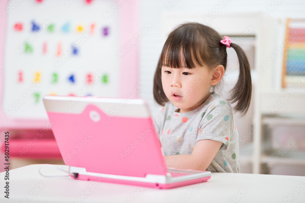 young girl using laptop for online learning during lockdown time young girl using laptop for online learning during lockdown time