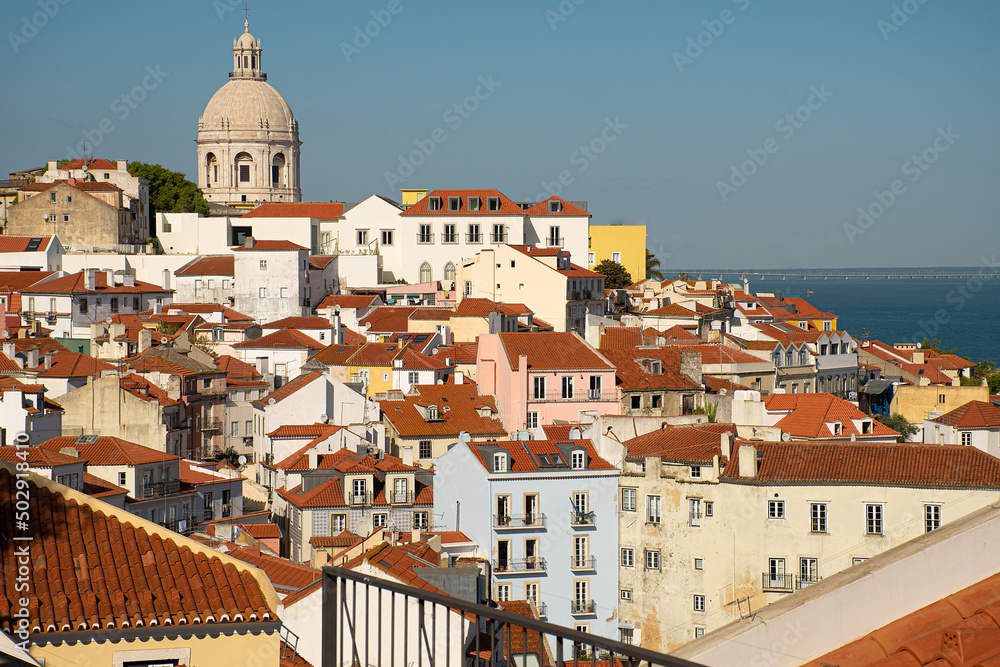 Views of the Alfama district in Lisbon from nearby lookout points, a combination of red-roofed buildings.