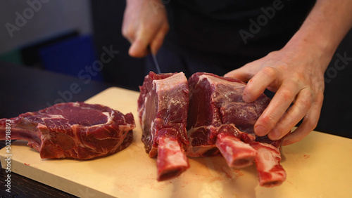 Man slices meat steaks