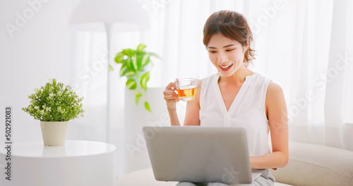 asian women uses laptop leisurly