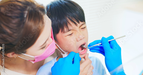 dentist examining toothache boy