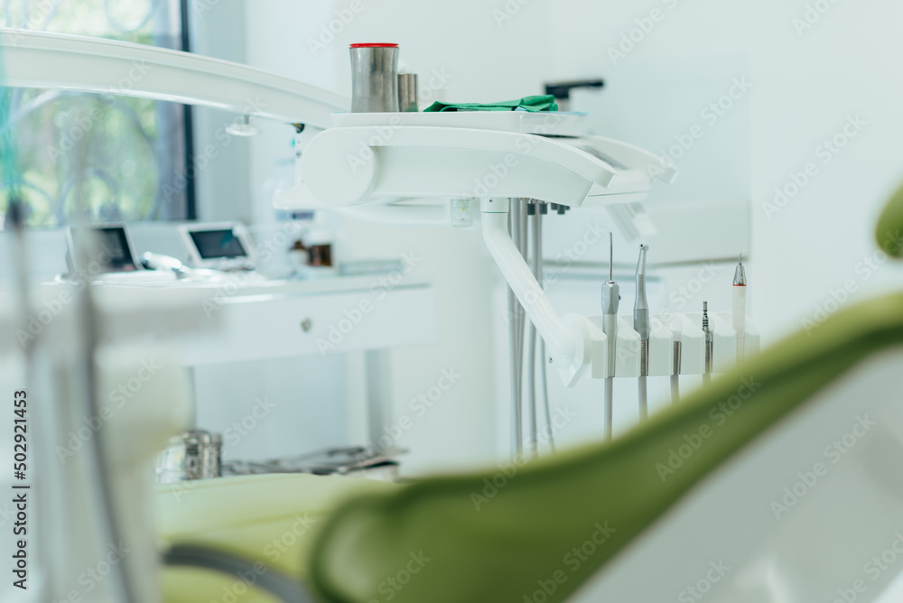 Detail of a dental tools attached to a dental chair in a dental clinic Detail of a dental tools attached to a dental chair in a dental clinic