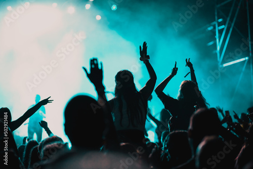 Fototapeta Naklejka Na Ścianę i Meble -  cheering crowd with raised hands at concert - music festival