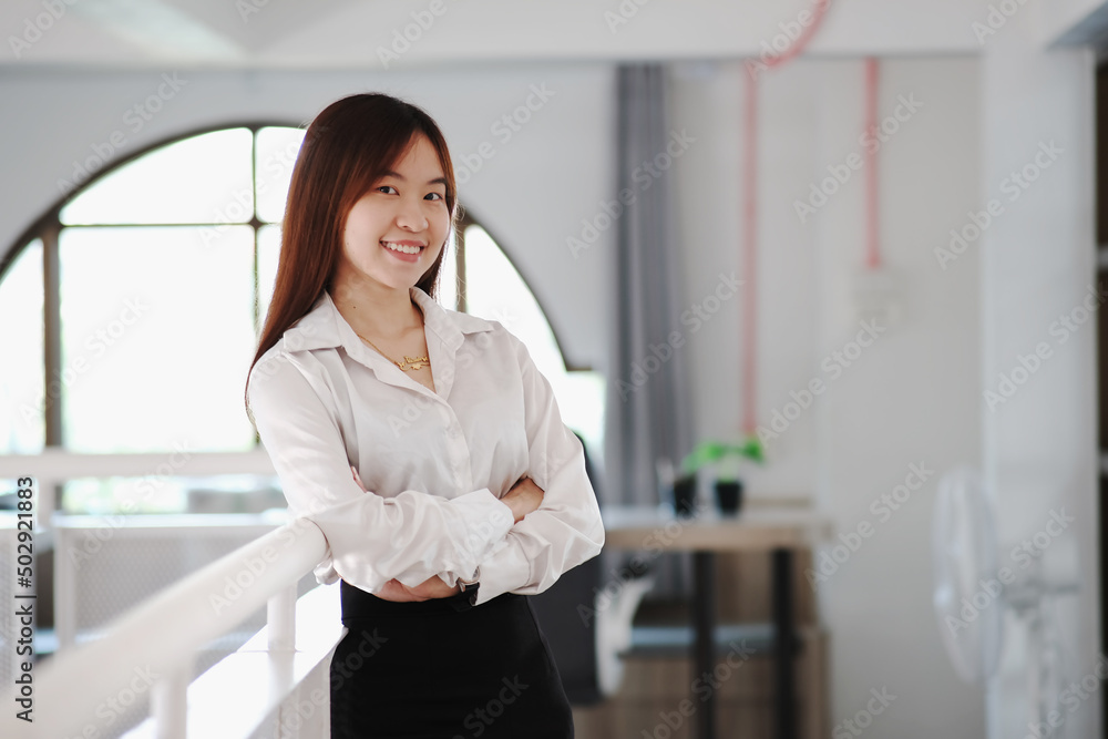 Women asian confidence team leader business staring at camera and smiling in modern office area Women asian confidence team leader business staring at camera and smiling in modern office area