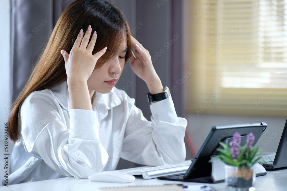 Tired and overworked business woman. Young exhausted girl sleeping on table during her work using laptop, digital tablet and smartphone Tired and overworked business woman. Young exhausted girl sleeping on table during her work using laptop, digital tablet and smartphone