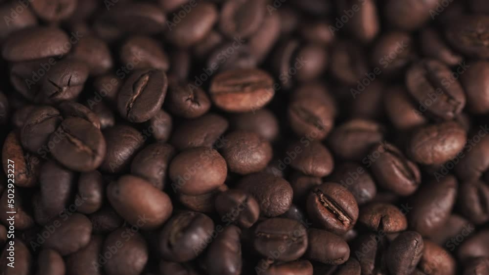 Coffee beans on, camera moves , close up.Freshly roasted coffee on canvas.Coffee beans in the bag.A handful of coffee beans on a brown canvas. Coffee beans on, camera moves , close up.Freshly roasted coffee on canvas.Coffee beans in the bag.A handful of coffee beans on a brown canvas.