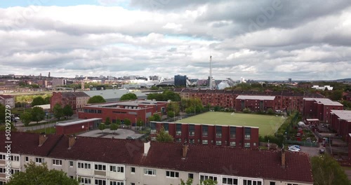 Aerial shot of Glasgow from Govan featuring houses, apartments, flats tenements, river Clyde, schools and landmarks including science centre tower, Hydro and SEC