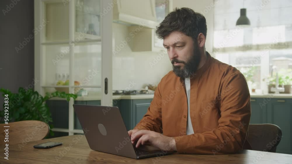 Young adult enterpreneur working on a laptop indoors Young adult enterpreneur working on a laptop indoors