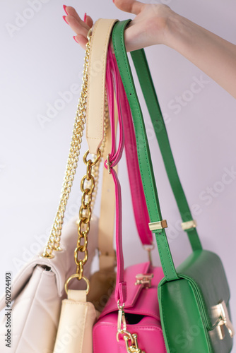woman hand holding set of colorful bags. Product composition photography. handbag and purse for women