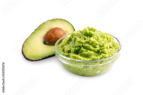 Healthy homemade mexican dip, sauce or spread made of mashed ripe green raw avocado served in glass bowl with ingredient as snack for vegan or vegetarian dieting isolated on white background