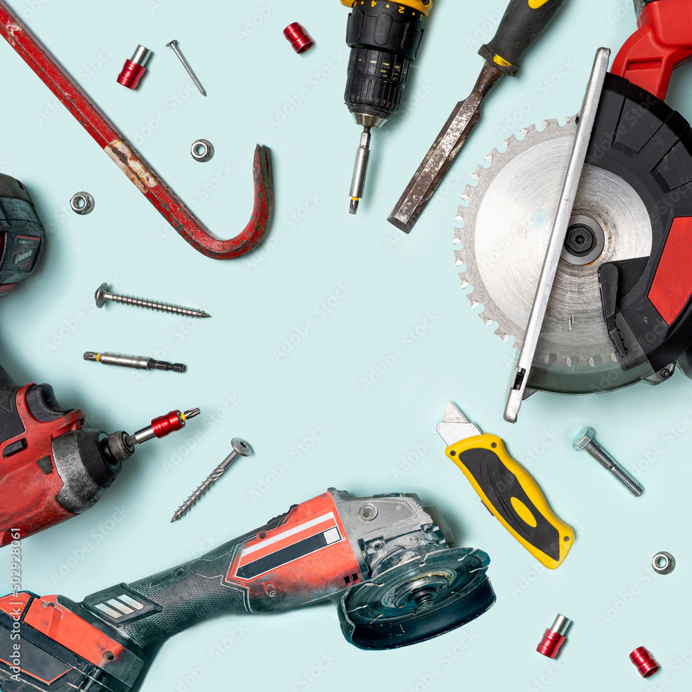 Arrangement of disc from circular saw, hammer, meter, stainless multi pliers. scalpel, tool kits, screwdrivers, and other tools with on pastel blue background. Top view. Circular creative copy space. Arrangement of disc from circular saw, hammer, meter, stainless multi pliers. scalpel, tool kits, screwdrivers, and other tools with on pastel blue background. Top view. Circular creative copy space.