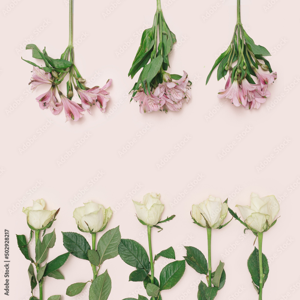 Three pink lilies that come from top and five white roses from botton on a pink background with a creative writing space. Top view.