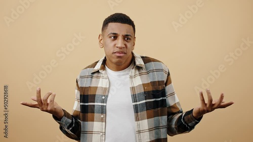 Ignorance concept. Studio portrait of young puzzled black guy saying I don't know, thinking and rejecting