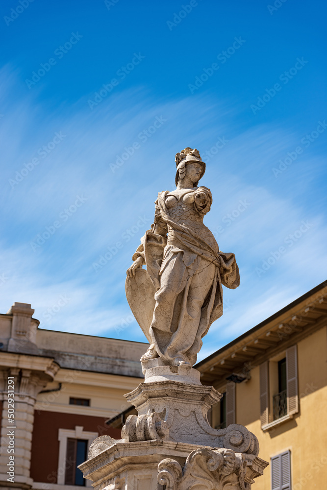 Fototapeta premium Brescia. Closeup of the marble statue and fountain of Brescia Armata (Brescia Armed) by the Italian sculptor Antonio Calegari (1699-1777). Square Piazza Paolo VI or Piazza del Duomo. Lombardy, Italy.