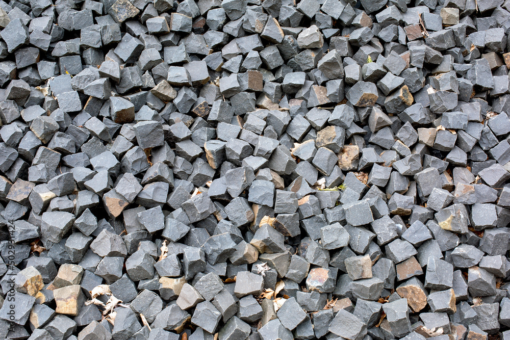 Many square stones for paving the road lie on the road as background, texture, pattern. Many square stones for paving the road lie on the road as background, texture, pattern.