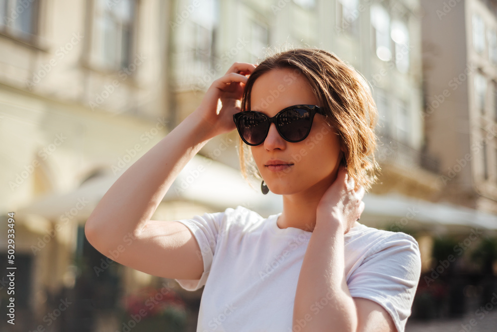 Portrait of young woman in sunglasses and white t-shirt Portrait of young woman in sunglasses and white t-shirt