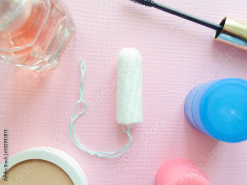 Female tampon on a pink background. Hygienic white tampon for women. Cotton swab. Menstruation, protection concept. Flat Lay