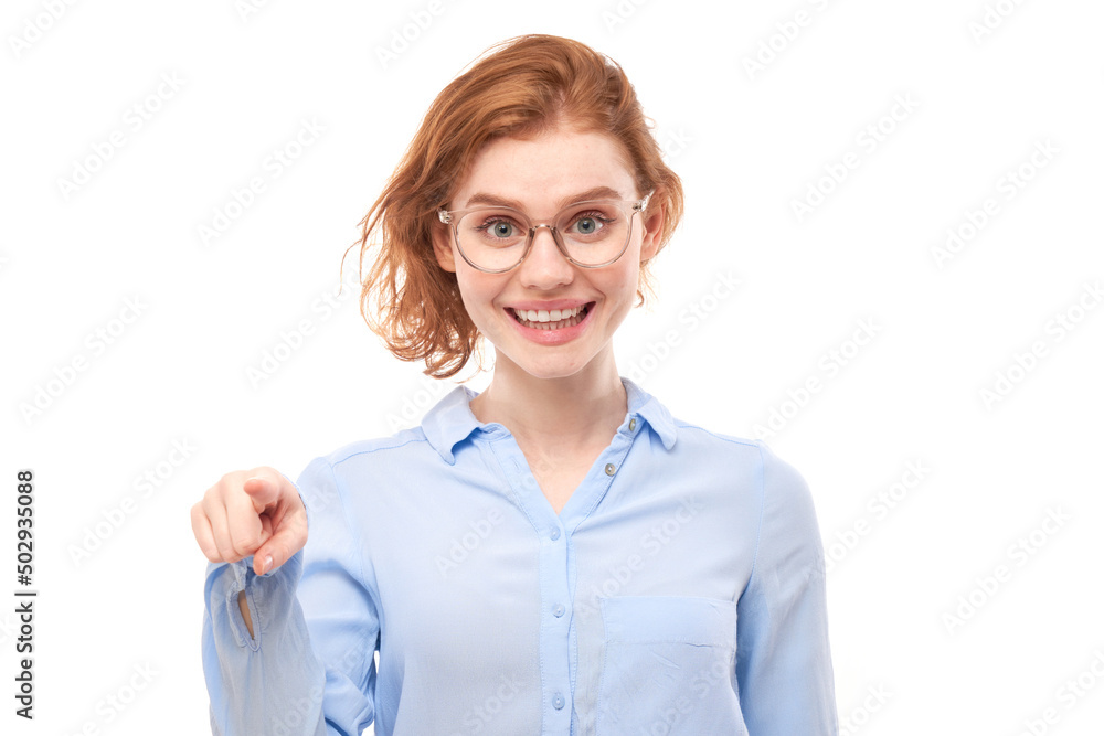 Portrait of friendly redhead girl chooses you, points finger at the camera isolated on white background Portrait of friendly redhead girl chooses you, points finger at the camera isolated on white background