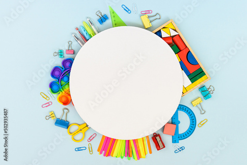 Round frame with stationery on the blue background, flatlay, copyspace