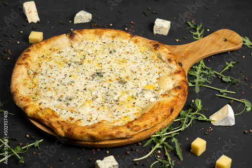 Pizza with cheese on a black background. Khachapuri